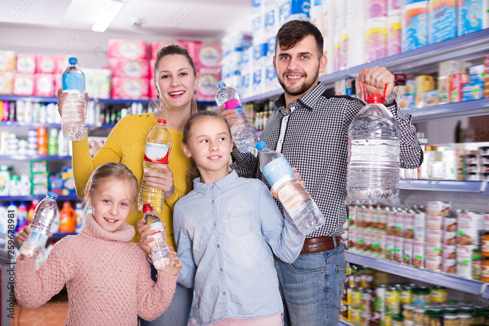 Young friendly family with bottles of water