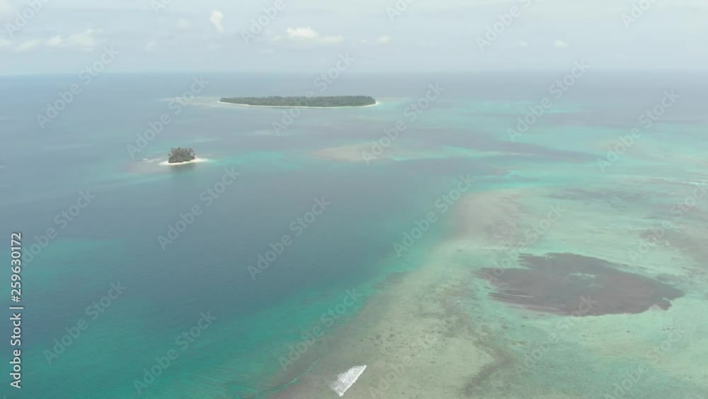Aerial: flying over coral reef tropical islands caribbean sea turquoise blue water. Indonesia Sumatra Banyak islands. Travel destination diving snorkeling. Native cinelike D-log color profile Aerial: flying over coral reef tropical islands caribbean sea turquoise blue water. Indonesia Sumatra Banyak islands. Travel destination diving snorkeling. Native cinelike D-log color profile