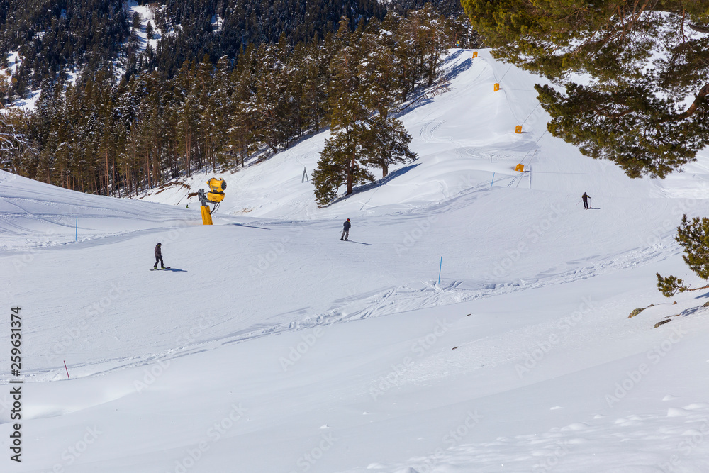 Skiers go down the mountain road