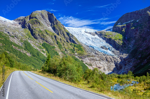 Norwegian landscape with road, glacier and green mountains. Norway