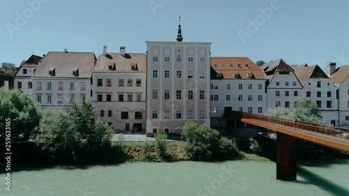 Beautiful symmetric and cinematic shot of small austrial or german town with simple tiny buildings, church and main square in pastel colors. Concept european architecture for travel blogger photo