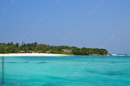 Fototapeta Naklejka Na Ścianę i Meble -  Beautiful tropical Maldives island with beach , sea , and coconut palm tree on blue sky for nature holiday vacation background concept -Boost up color Processing