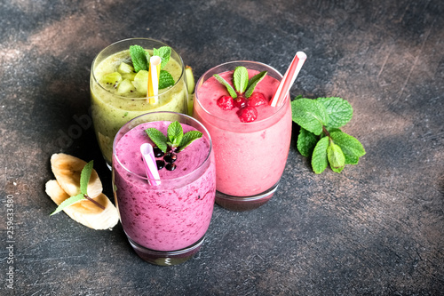 Fruit and berry smoothie blend at home on a dark background.