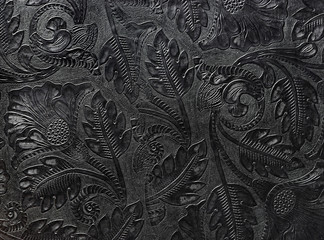 Embossed shiny black leather with the floral motif