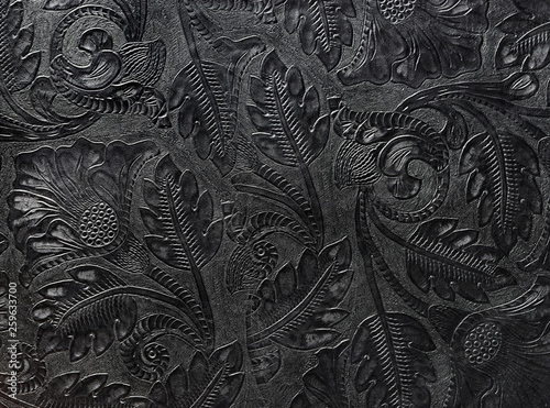 Embossed shiny black leather with the floral motif