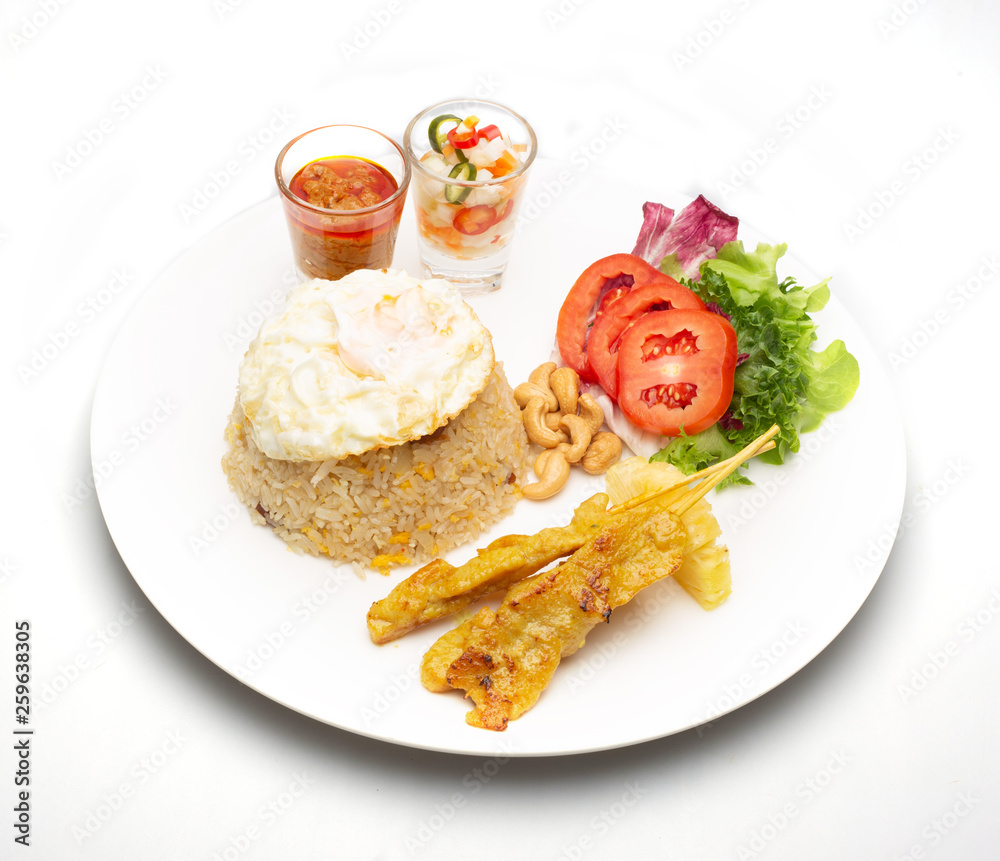 Fried rice with fried egg with grilled pork and salad .food isolated on white background .