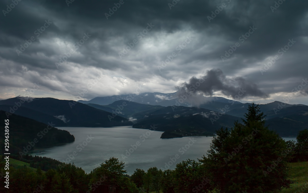 dark scene with lake and storm clouds