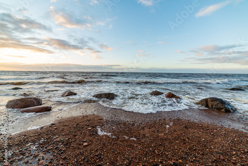 storm weather on the beach by rocky sea shore