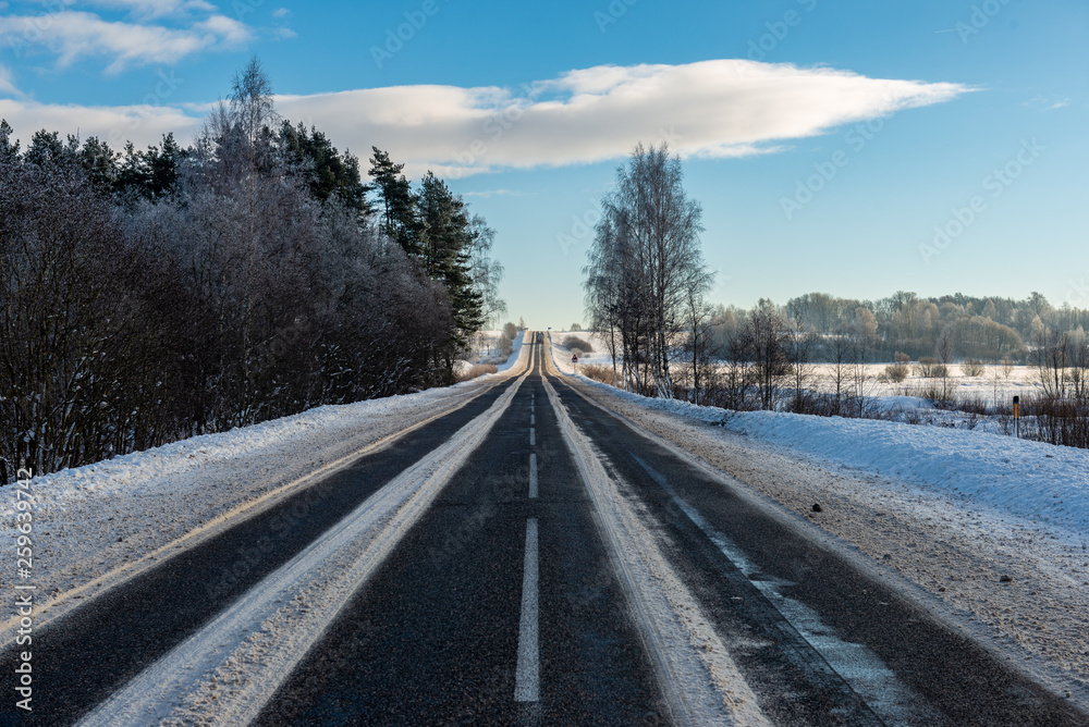 snowy winter road covered in ice and snow snowy winter road covered in ice and snow