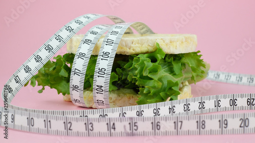 vegetarian sandwich with green salad and puffed rice cake. Tape measure and weight loss.