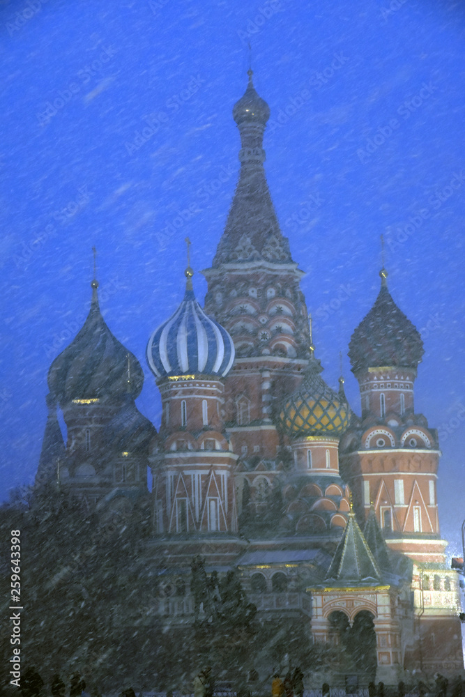 Saint Basils cathedral on the Red Square in Moscow at snowstorm. Color night photo.