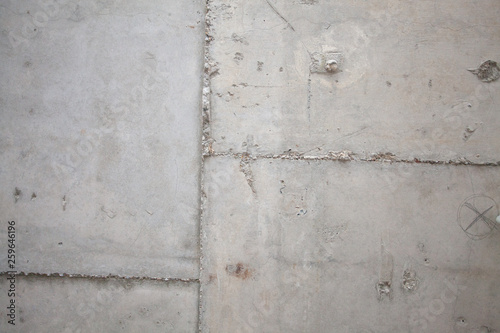 Formwork traces on concrete. Repair and construction or constructing. Concrete background. Grey color. Cement texture. Poor quality curve wall. Flaws, defects and cracks in the wall. .