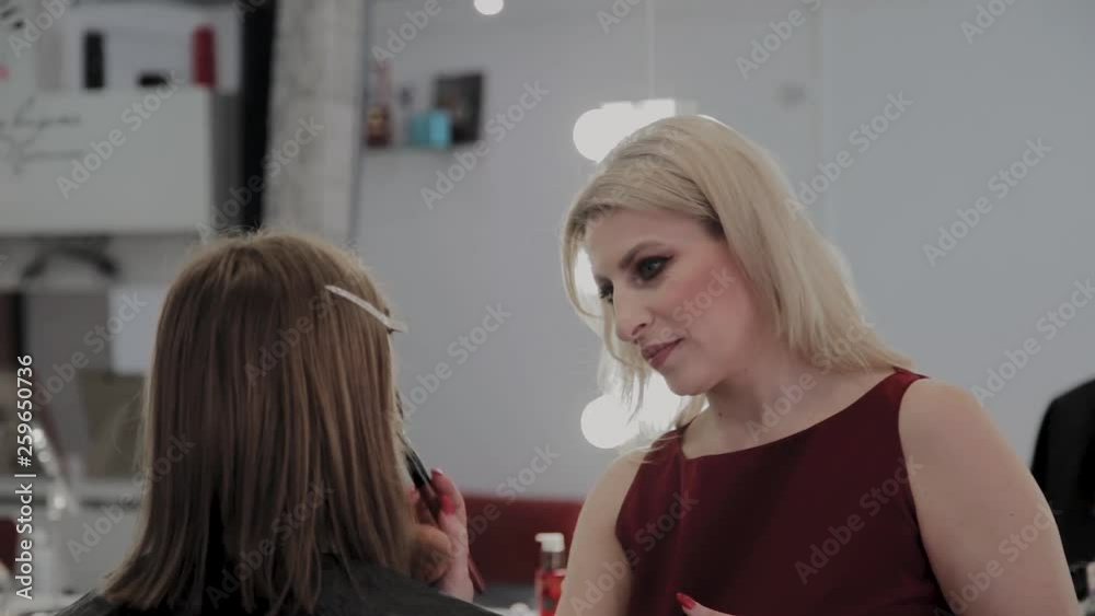 Makeup artist applies professional makeup to a beautiful young girl. New concept in makeup. Makeup artist applies professional makeup to a beautiful young girl. New concept in makeup.