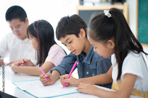 Group of Students study math with teacher in the classroom