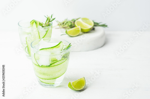 Fresh cucumber drink sprig of rosemary on a white background. Summer refreshing detox. Selective focus.