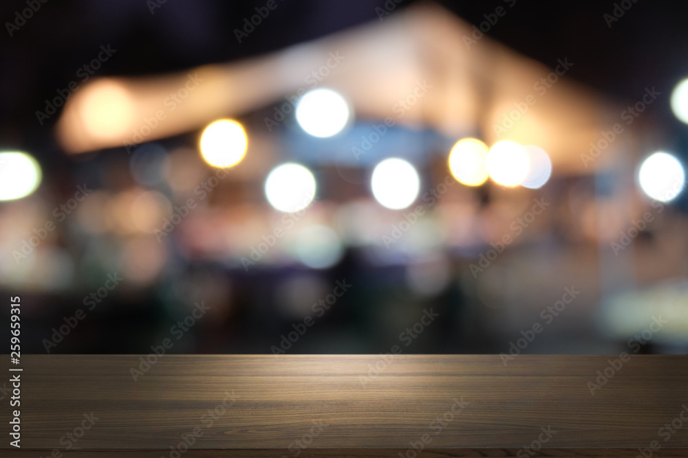 Empty dark wooden table in front of abstract blurred bokeh background of restaurant . can be used for display or montage your products.Mock up for space. Empty dark wooden table in front of abstract blurred bokeh background of restaurant . can be used for display or montage your products.Mock up for space.