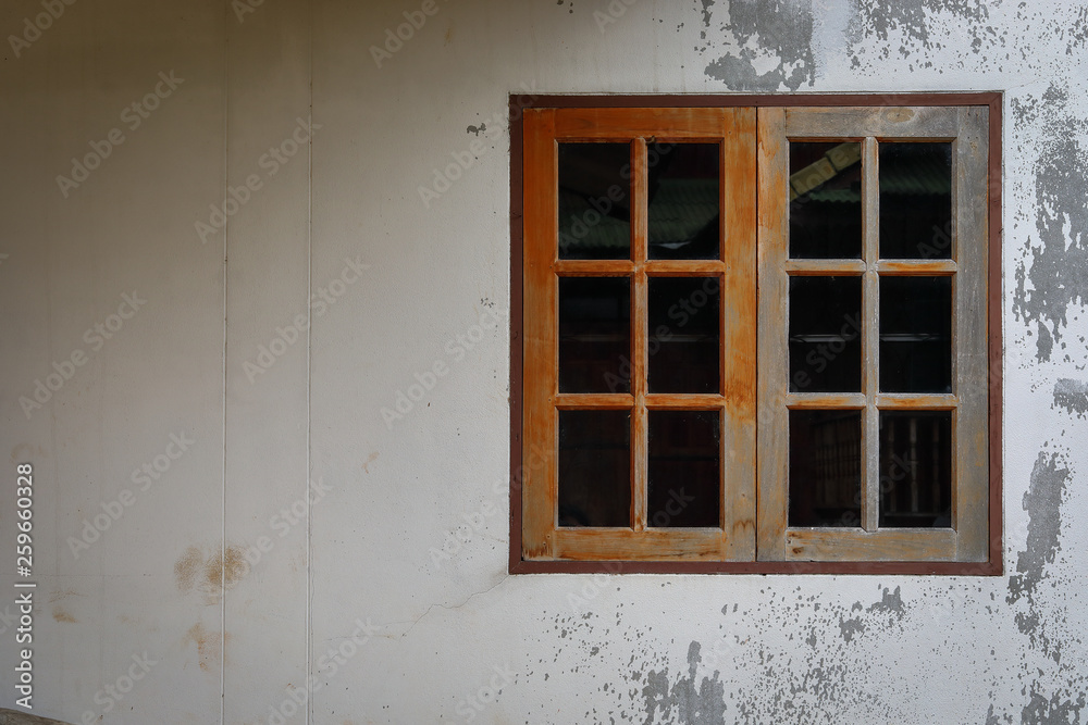 Fototapeta premium old glass window with wooden frame on weathered wall