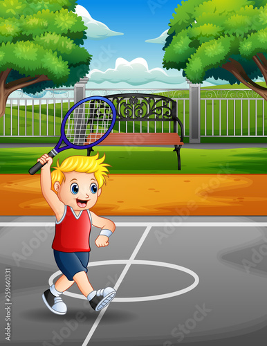 Happy boy playing tennis at the courts