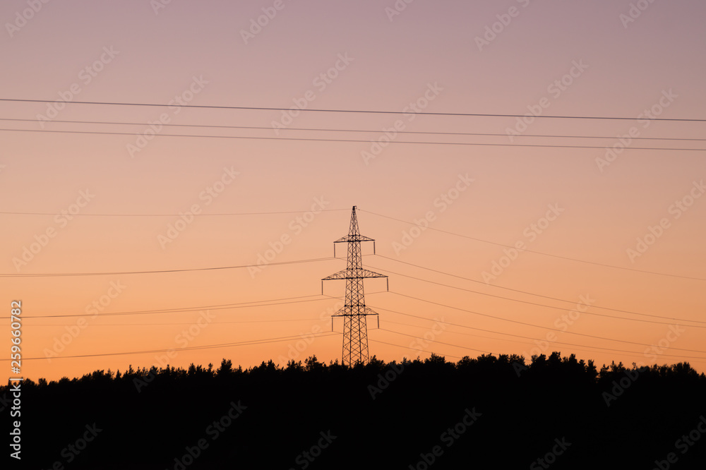 High voltage tower with silhouette sky sunset background