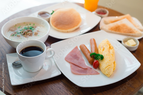 breakfast on table with Omelet, bread, coffee and juice