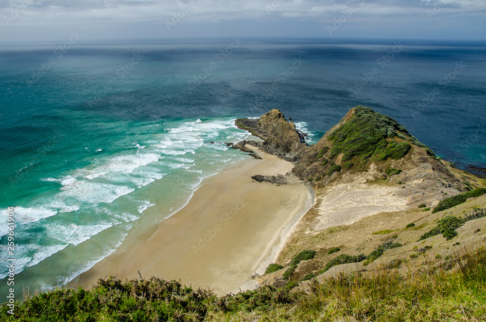 Coastline view from Cape Reinga with blue sky and white clouds above, Northland, New Zealand Coastline view from Cape Reinga with blue sky and white clouds above, Northland, New Zealand