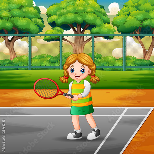 Happy girl playing tennis at the courts