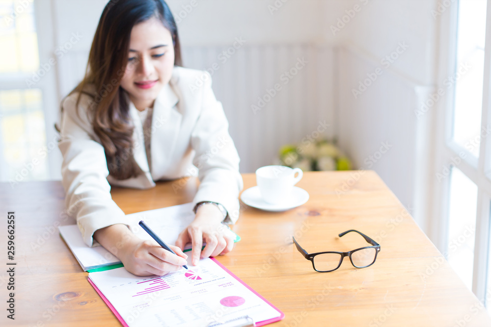 Protrait of Beautiful businesswoman sitting at desk and working with laptop computer. Protrait of Beautiful businesswoman sitting at desk and working with laptop computer.
