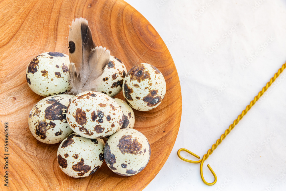 Quail eggs in a wooden bowl Quail eggs in a wooden bowl
