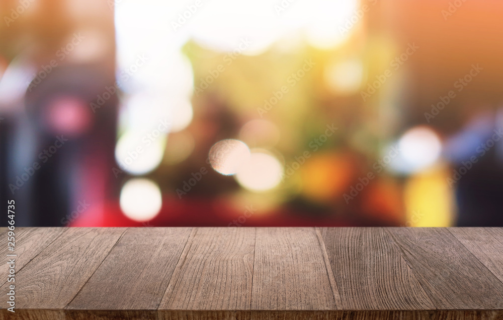 Empty dark wooden table in front of abstract blurred bokeh background of restaurant . can be used for display or montage your products.Mock up for space.