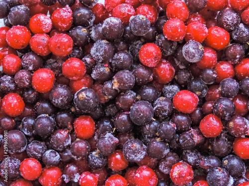 Frozen berries. Top view. Assorted frozen berries background. Raspberries  black currant and strawberries on blue background  copy space. Fresh organic berries macro. Fruit background. Close up.