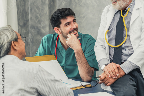 Male doctor team talking to senior patient visit at the hospital office. Medical healthcare staff service concept. photo