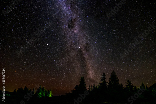 A stunning scene of the starry night over the mountain. Long explosure and high ISO photo.