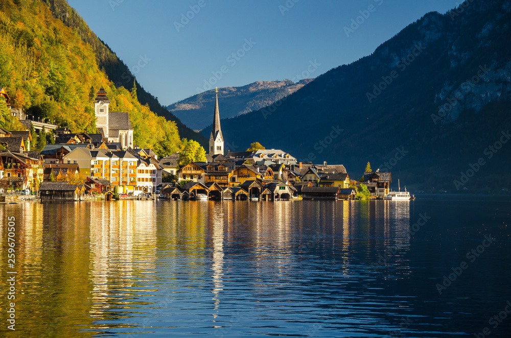 View of Hallstatt Hallstadt town with reflection in lake with blue sky above, Austria