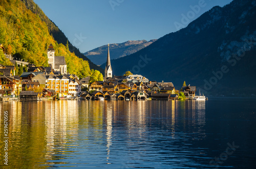 View of Hallstatt Hallstadt town with reflection in lake with blue sky above, Austria