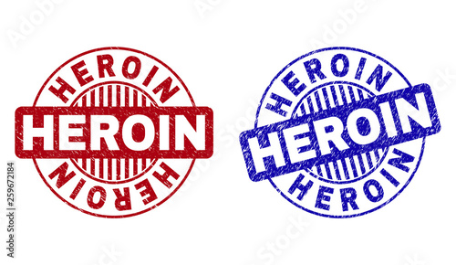 Grunge HEROIN round stamp seals isolated on a white background. Round seals with grunge texture in red and blue colors. Vector rubber imitation of HEROIN title inside circle form with stripes.