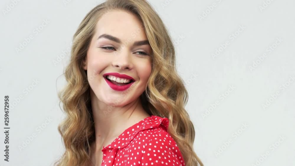 Happy expressive young woman with cheerful emotions. Beautiful blonde. Happiness concept. Attractive fashion model with a red lipstick on the lips. Slow motion footage. Happy expressive young woman with cheerful emotions. Beautiful blonde. Happiness concept. Attractive fashion model with a red lipstick on the lips. Slow motion footage.