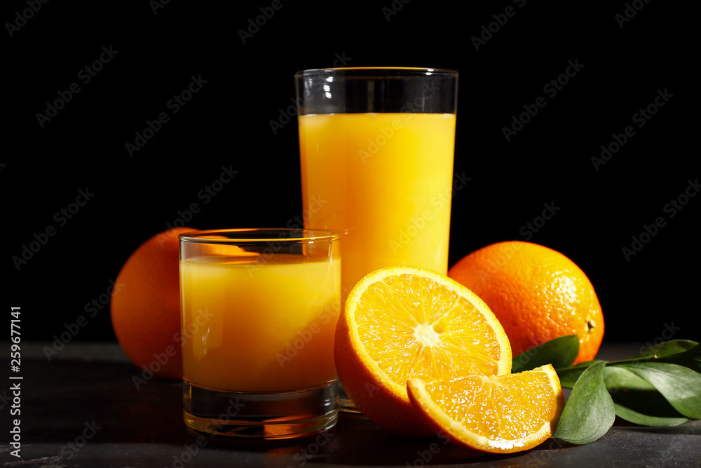 Glasses of orange juice on dark background Glasses of orange juice on dark background
