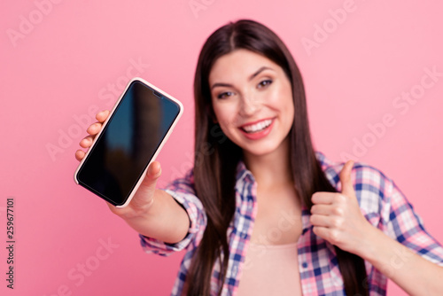 Close-up portrait of her she nice-looking attractive cute charming shine lovely cheerful cheery straight-haired lady showing black screen thumbup isolated over pink pastel background