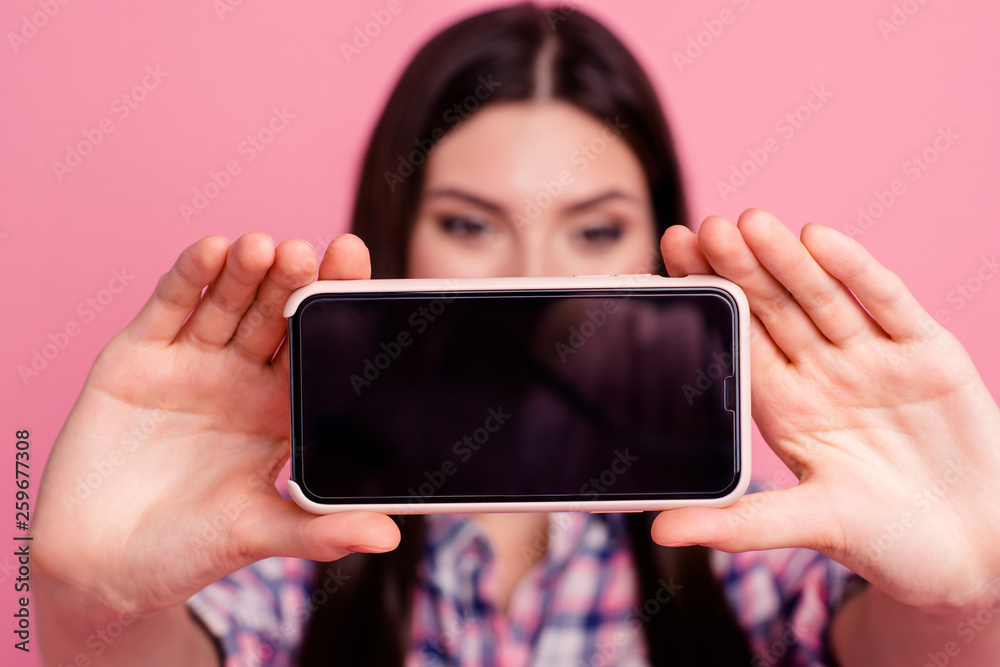 Close-up portrait of her she nice attractive cute charming straight-haired lady in checked shirt holding in hands cell making taking selfie isolated on pink pastel background