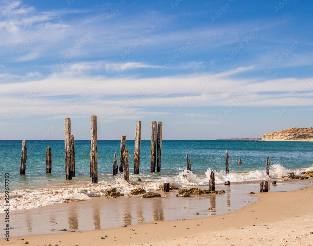 Old wooden pier posts at Port Willunga beach, Adelaid, South Australia Old wooden pier posts at Port Willunga beach, Adelaid, South Australia