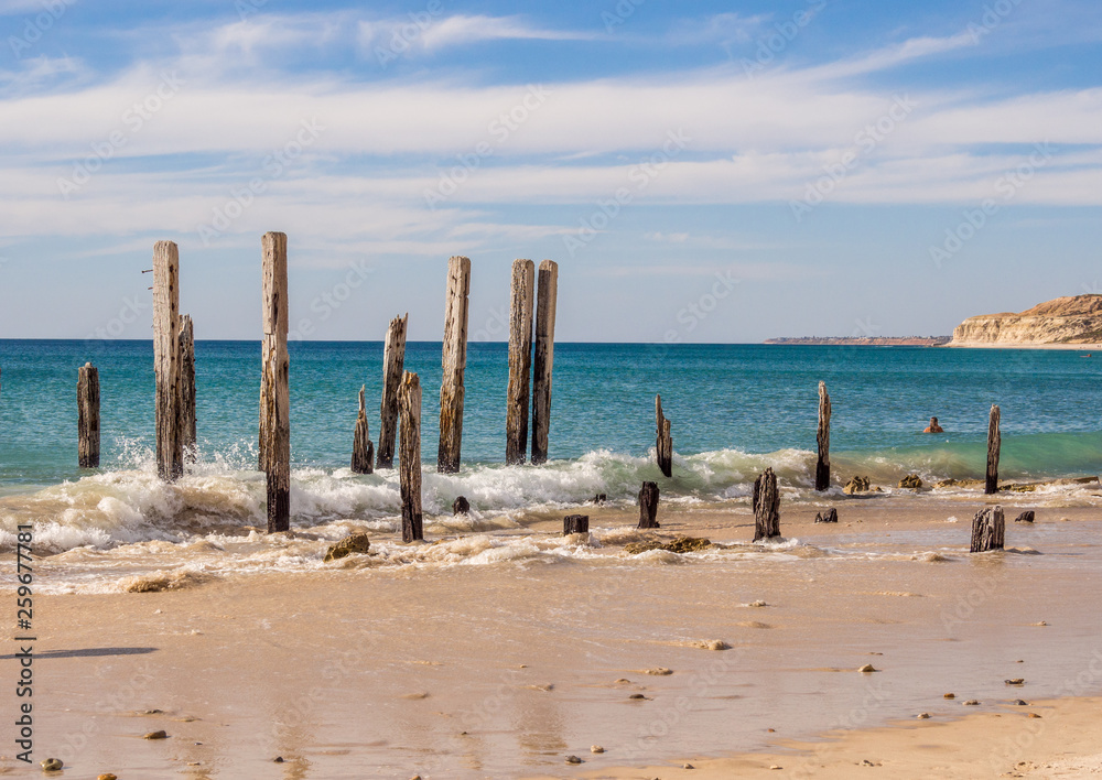 Old wooden pier posts at Port Willunga beach, Adelaid, South Australia
