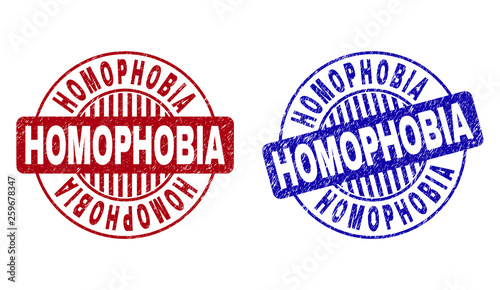 Grunge HOMOPHOBIA round stamp seals isolated on a white background. Round seals with grunge texture in red and blue colors. Vector rubber overlay of HOMOPHOBIA tag inside circle form with stripes.