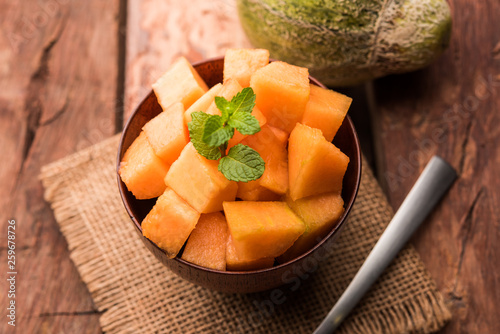 Cantaloupe / muskmelon / kharbuja cut into pieces, served in a bowl. selective focus photo