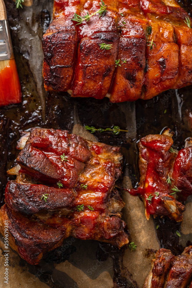 Grilled pork ribs on baking paper, top view. Copy space. Grilled pork ribs on baking paper, top view. Copy space.