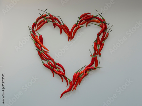 Close-up of Heart, symbol of love, designed from red hot chili cayenne peppers handful 