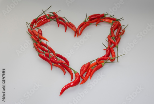 Close-up of Heart, symbol of love, designed from red hot chili cayenne peppers handful 