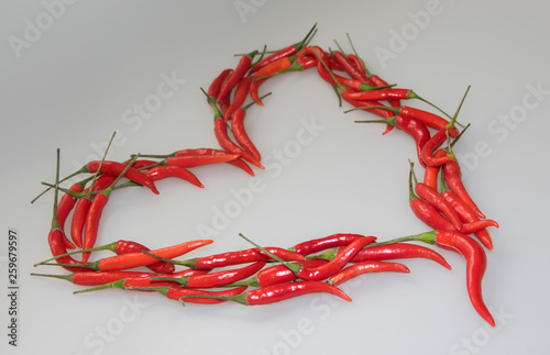 Close-up of Heart, symbol of love, designed from red hot chili cayenne peppers handful 