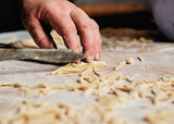Men`s hand cut The dough with a knife