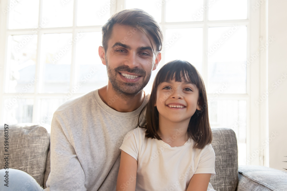 Father and daughter talking with friends or relatives using webcam Father and daughter talking with friends or relatives using webcam