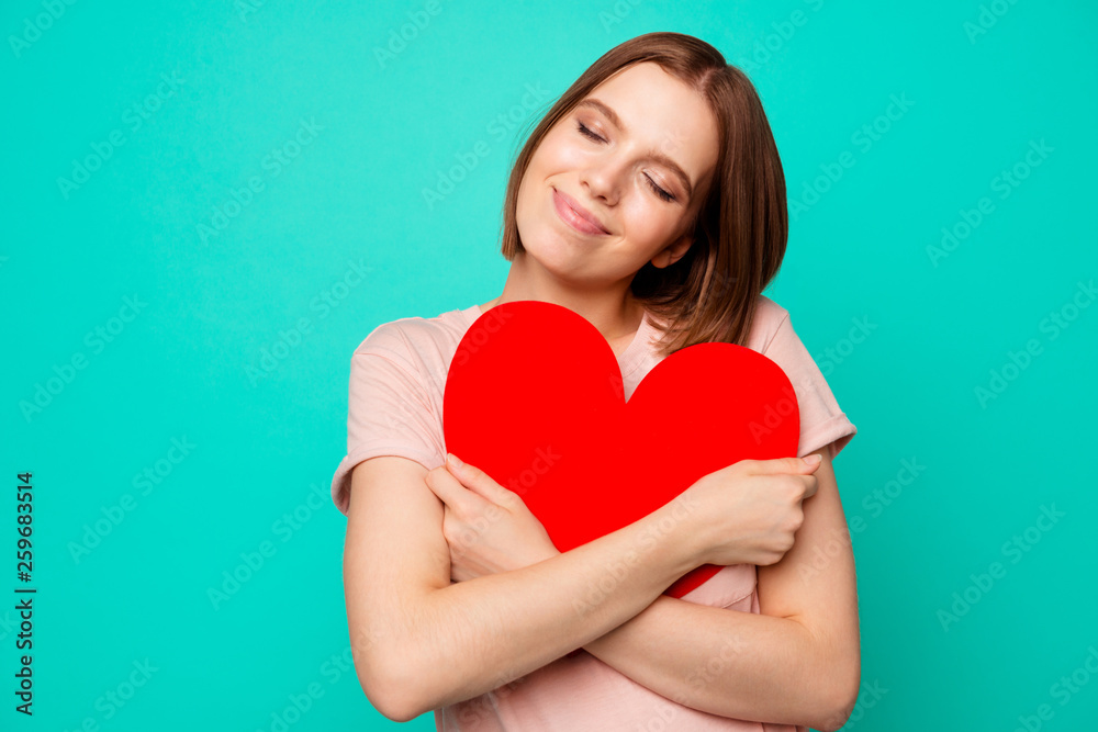 Close up photo beautiful funny funky her she lady hold close hands arms pretty sweet large heart shape figure postcard eyes closed wear casual pastel t-shirt clothes isolated teal turquoise background